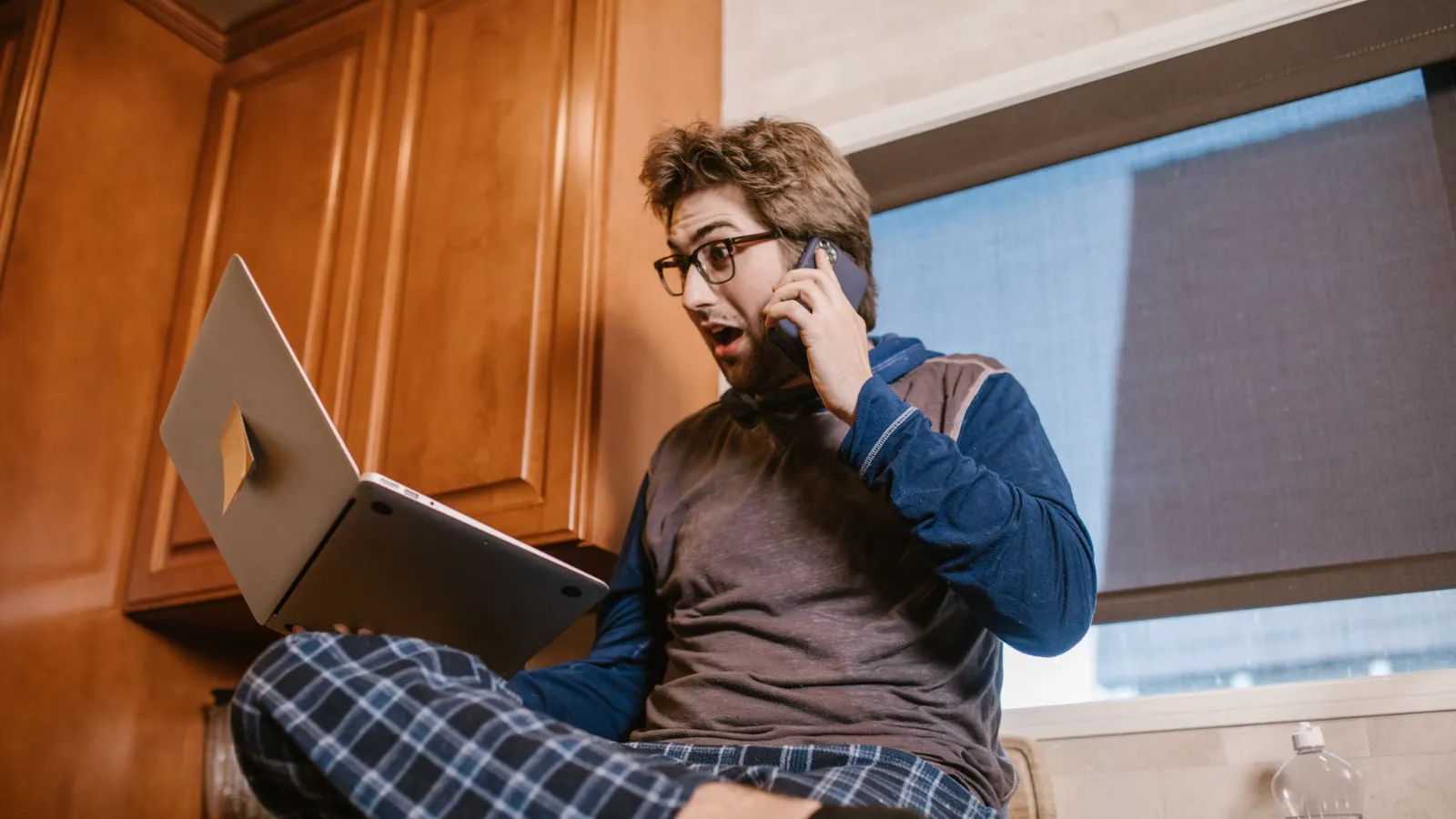 Surprised investor reacting to his laptop screen